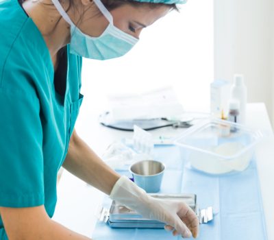 Portrait of doctor with many kind of medical equipment manage for to start operation in operating room.